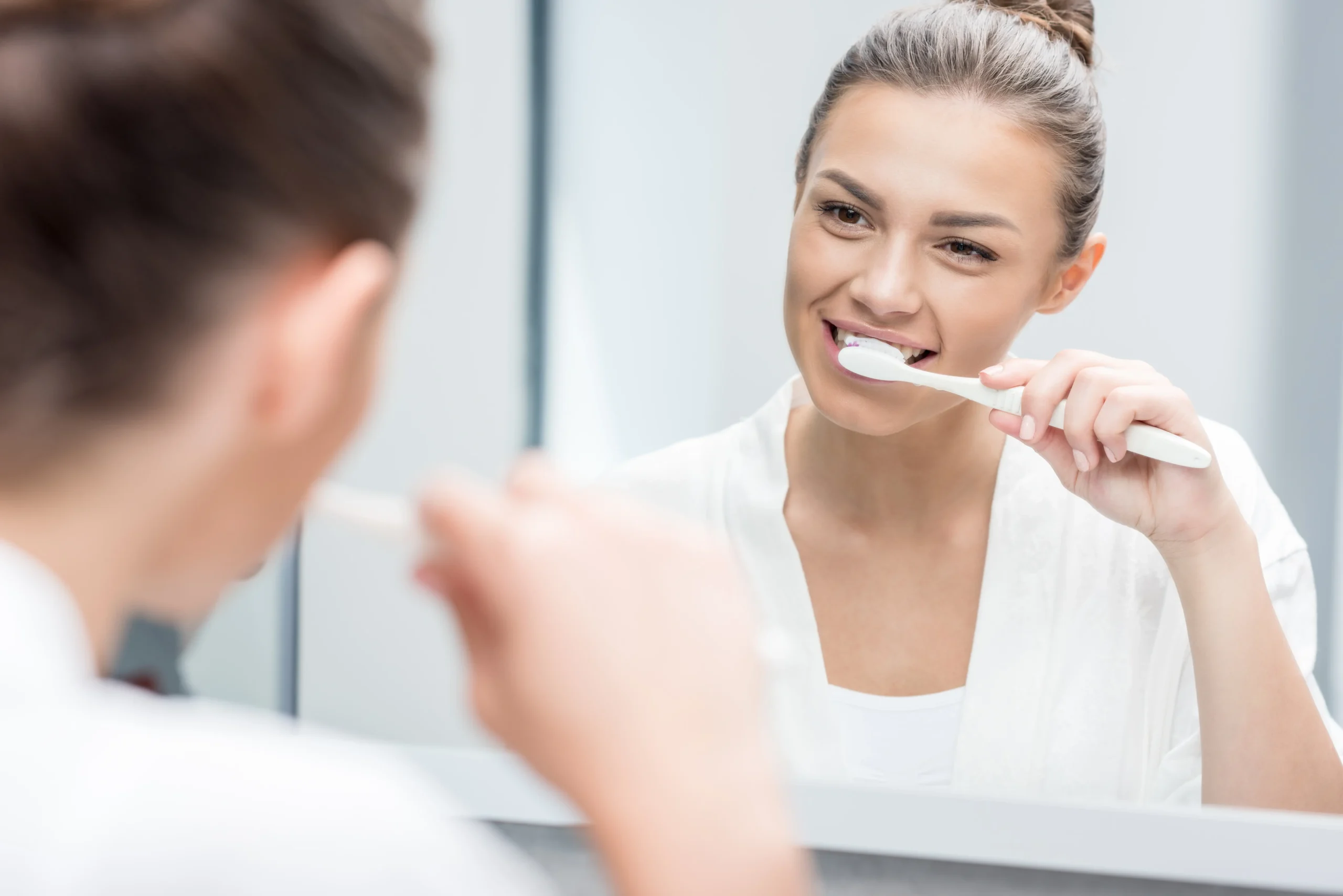 Woman-Brushing-Teeth-scaled