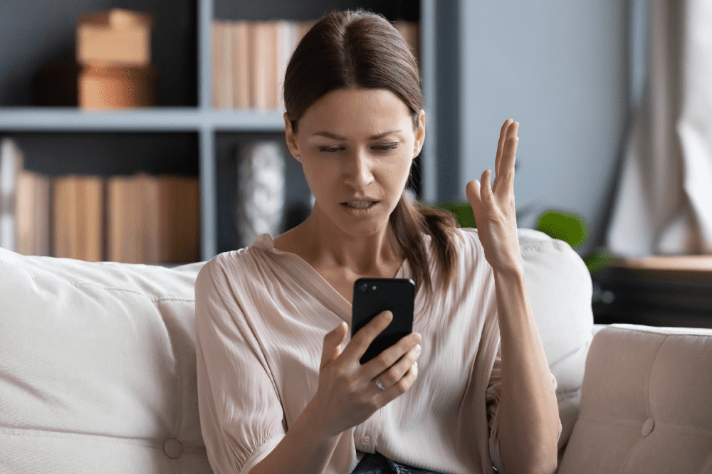 person-sits-on-a-couch-and-is-frustrated-with-a-bad-wi-fi-signal