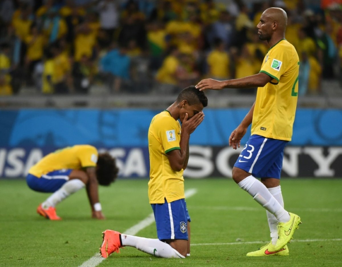 brazil-midfielder-luiz-gustavo--c--is-consoled-by-teammate-maicon-after-defeat-in-the-semi-final-football-match-between-brazil-and-germany-on-july-8--2014--during-the-2014-fifa-world-cup_20240708_113211657