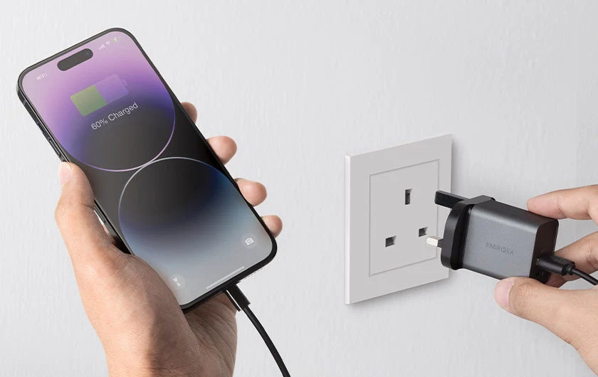 Image-of-a-person-charging-their-smartphone-with-an-adapter-plugged-to-a-wall-socket_844c4d62-2a40-457c-86dd-76b1203e5970