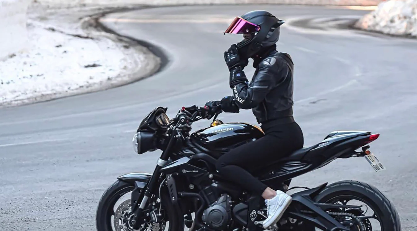 adjusting-motorcycle-helmet-snowy-road