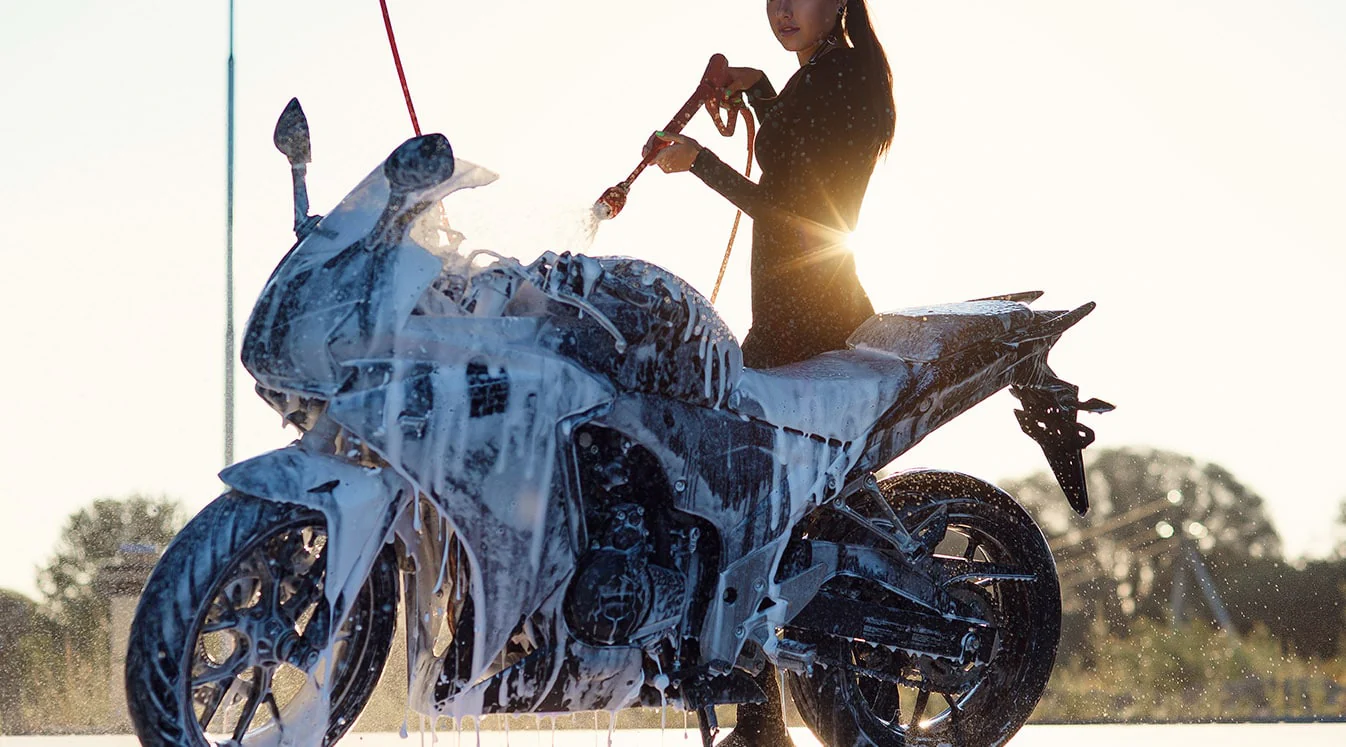 woman-washes-a-motorcycle-at-self-service-car-wash woman-washes-a-motorcycle-at-self-service-car-wash