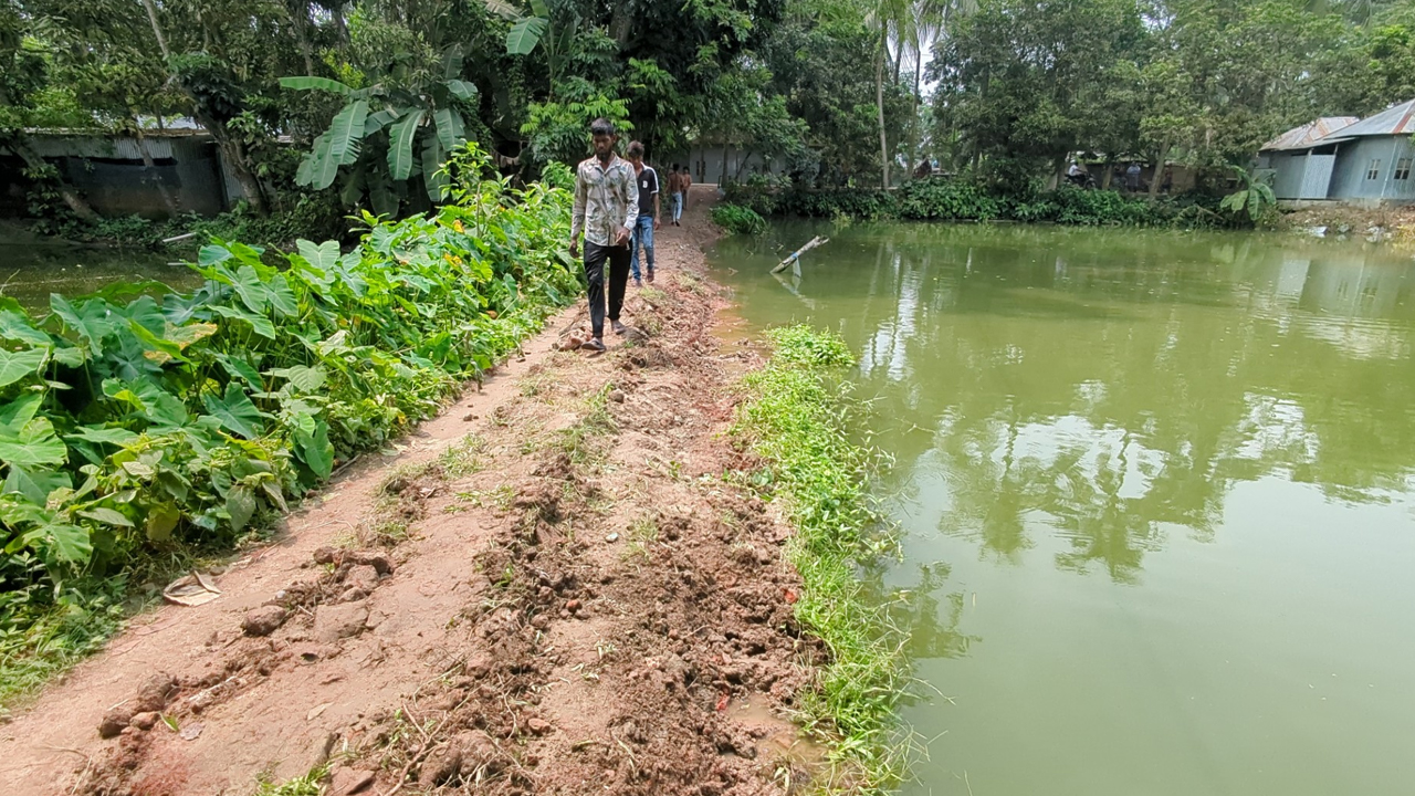Road_in_Rajbari_cut_open_into_a_pond
